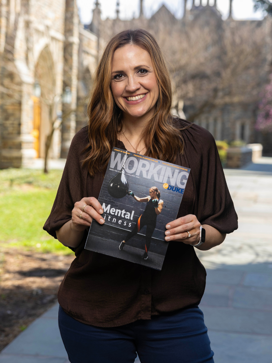 Rachel Meyer holds a Working@Duke magazine